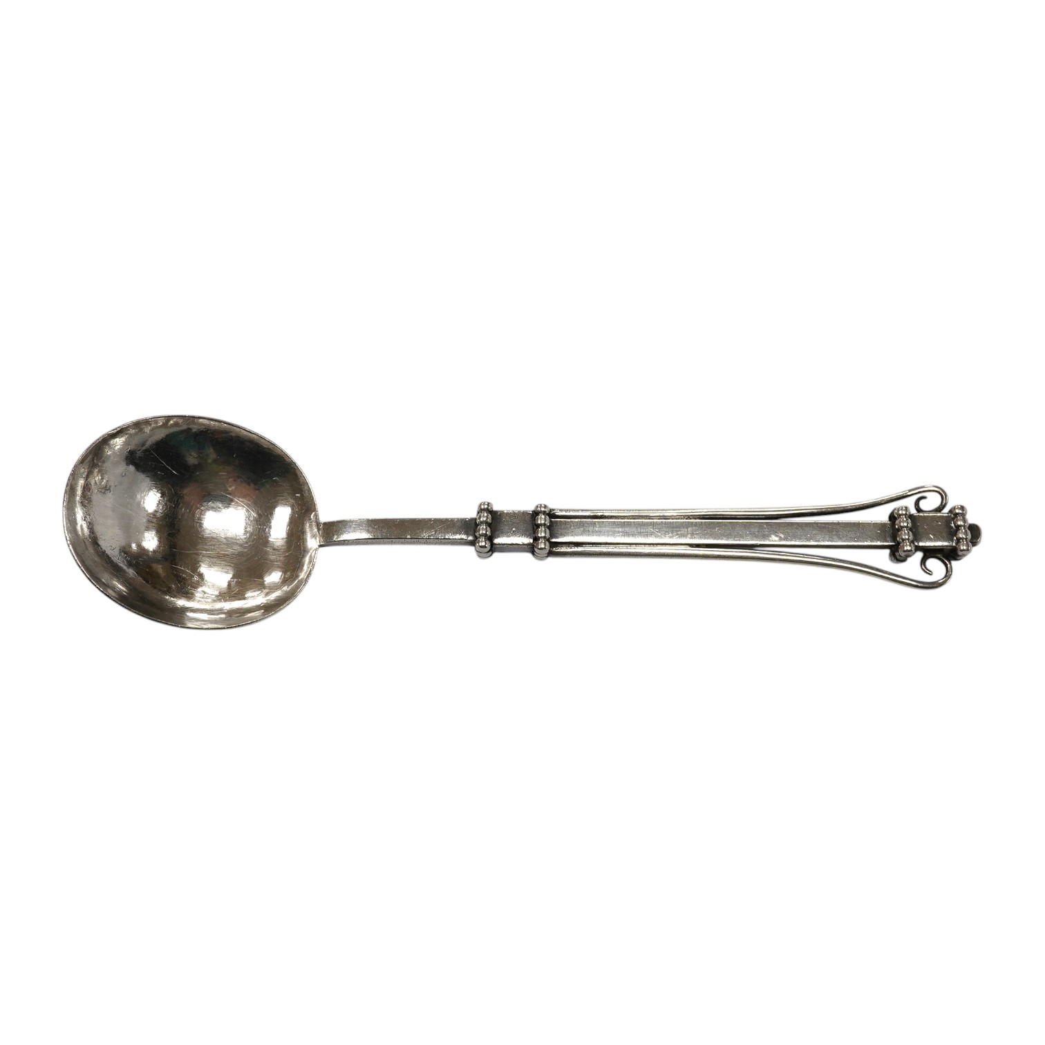 An Edwardian Arts & Crafts silver spoon, by Albert Edward Jones, Birmingham, 1907, 14.3cm. Condition - fair